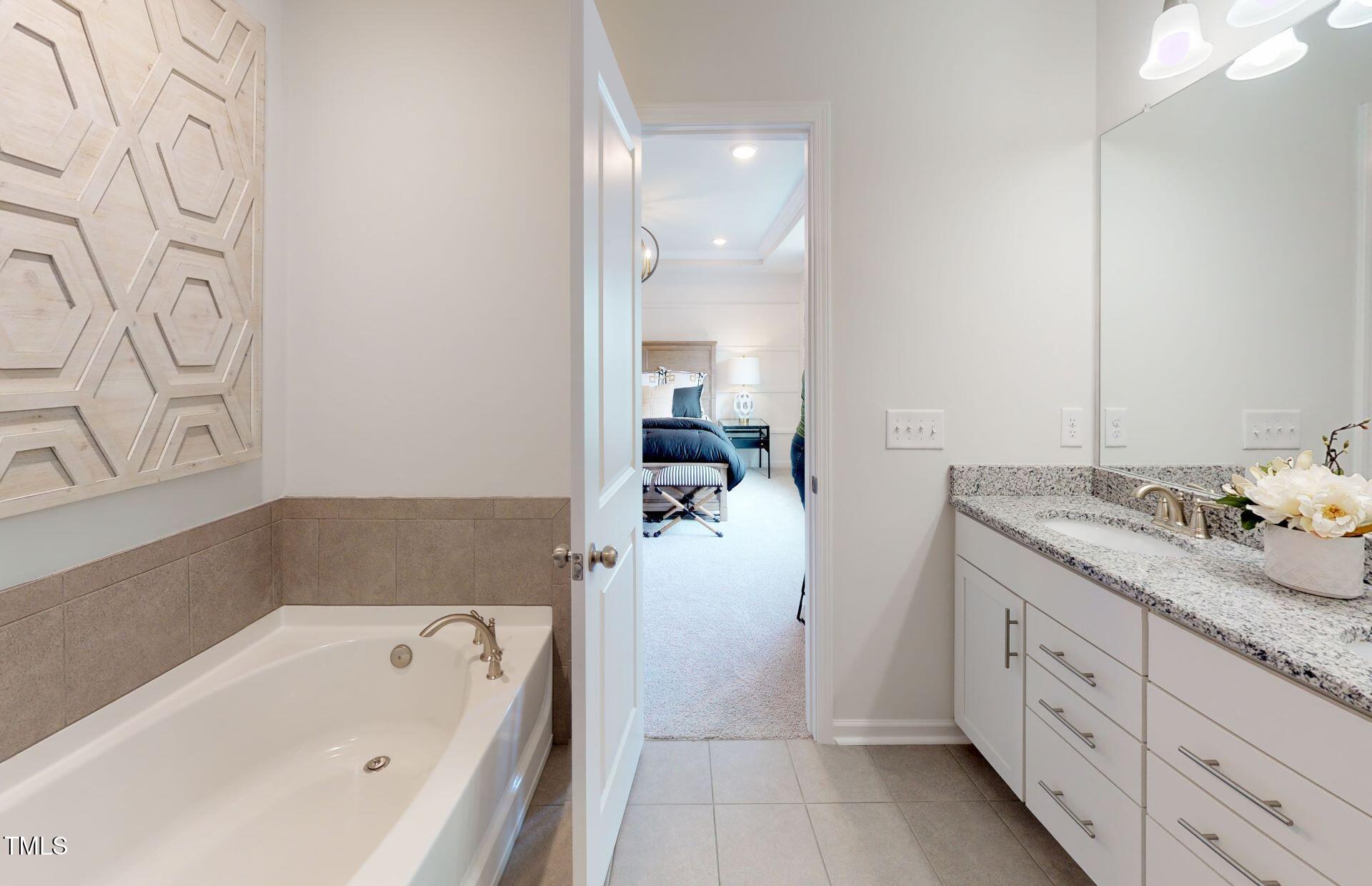1105 Freestone Road Durham, NC 27703 - Photo 15 of 21 a bathroom with a tub sink and mirror