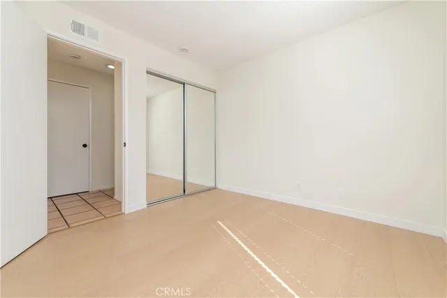 an empty room with a ceiling fan and glass door