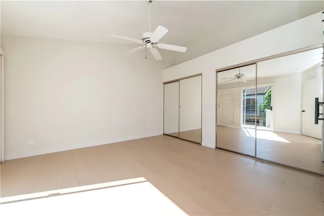 a big room with closet and a ceiling fan
