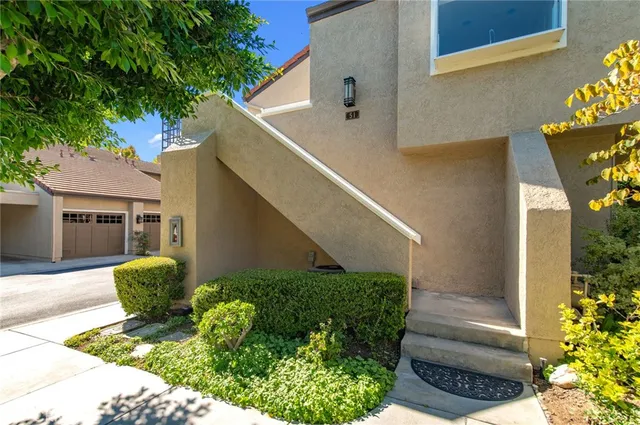 a view of a porch with a table and chair and potted plants