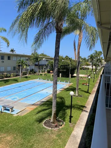 a swimming pool with outdoor seating and yard