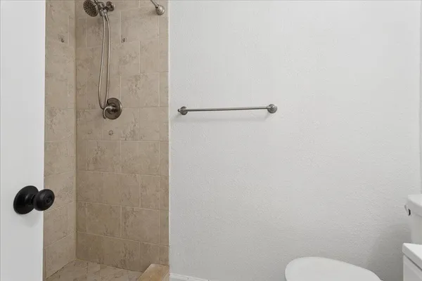 a bathroom with a shower toilet and a shower