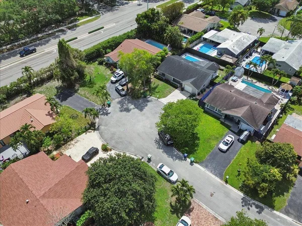 an aerial view of multiple houses with yard