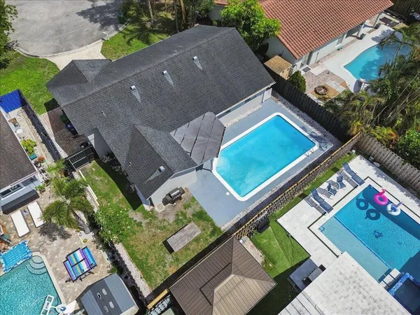 an aerial view of a house with a yard