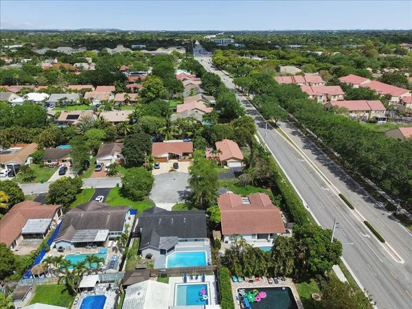 an aerial view of residential houses with outdoor space