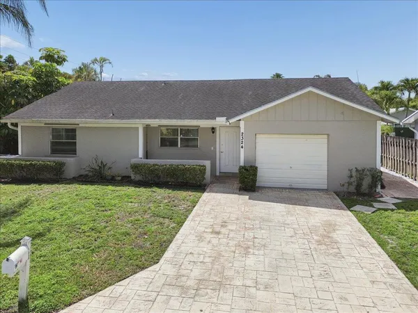 a front view of house with yard and trees