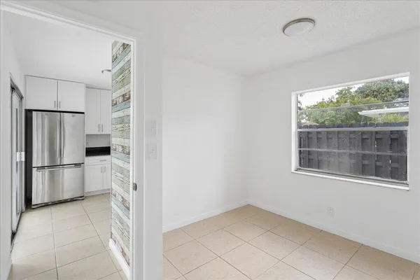 a view of a kitchen with a refrigerator a microwave and a sink