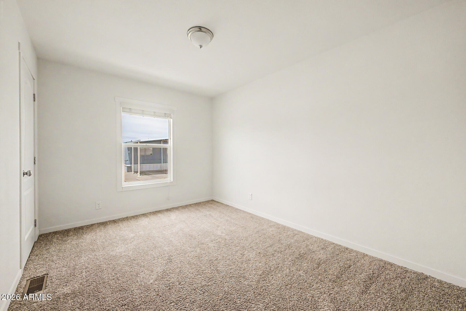 320 East McKellips Road, Unit 100 Mesa, AZ 85201 - Photo 16 of 24 a view of an empty room with a window