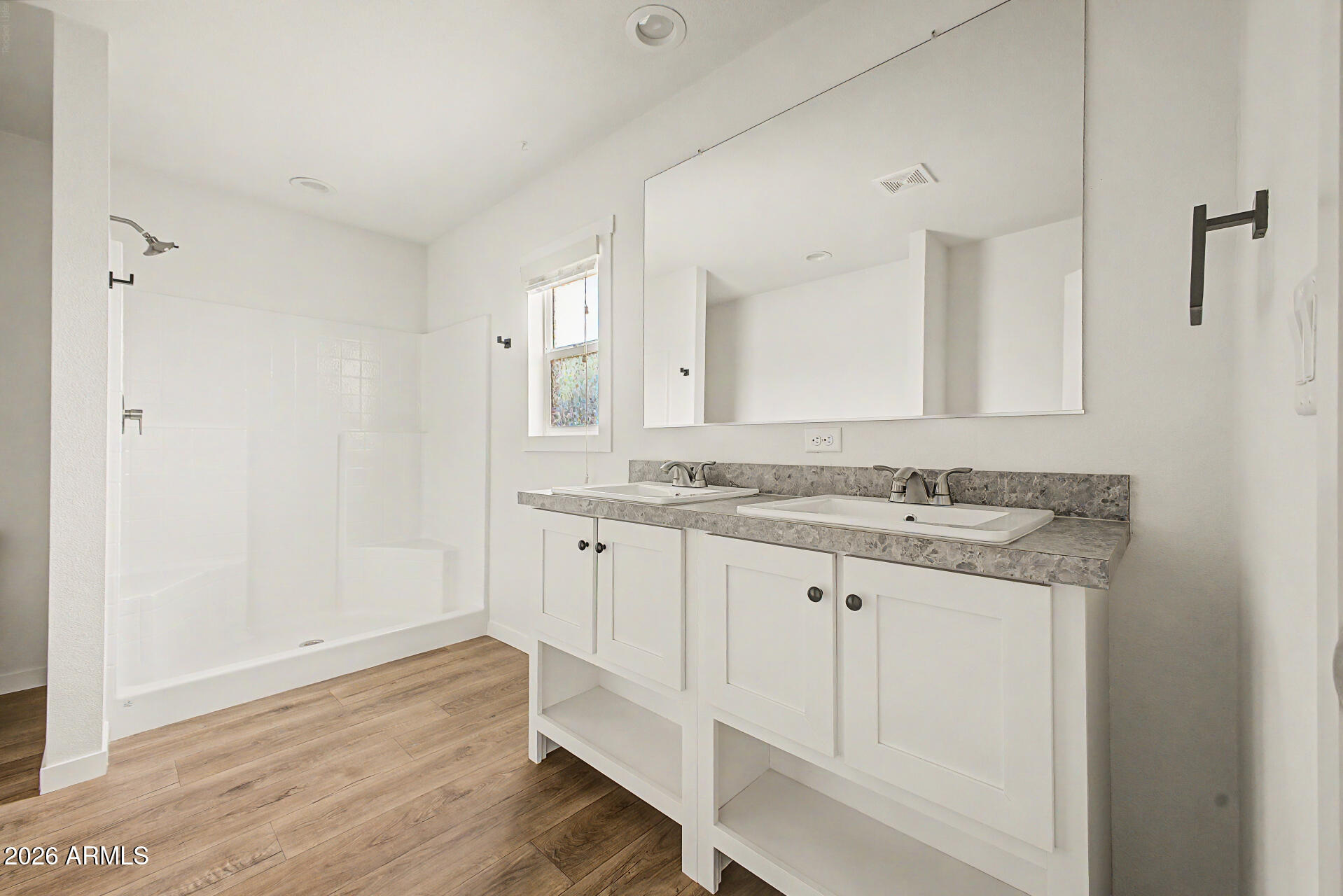 320 East McKellips Road, Unit 100 Mesa, AZ 85201 - Photo 20 of 24 a bathroom with granite countertop white cabinets and a sink