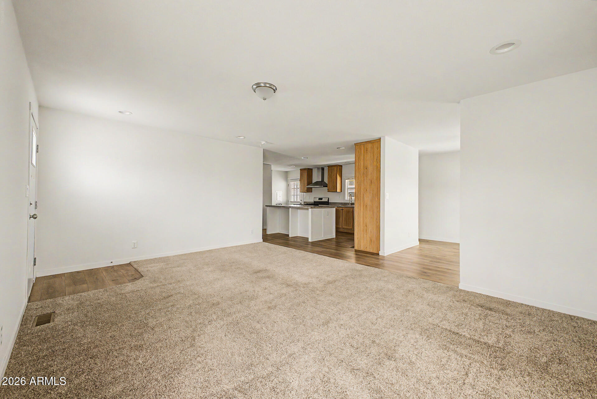 320 East McKellips Road, Unit 100 Mesa, AZ 85201 - Photo 6 of 24 an empty room with fireplace and windows