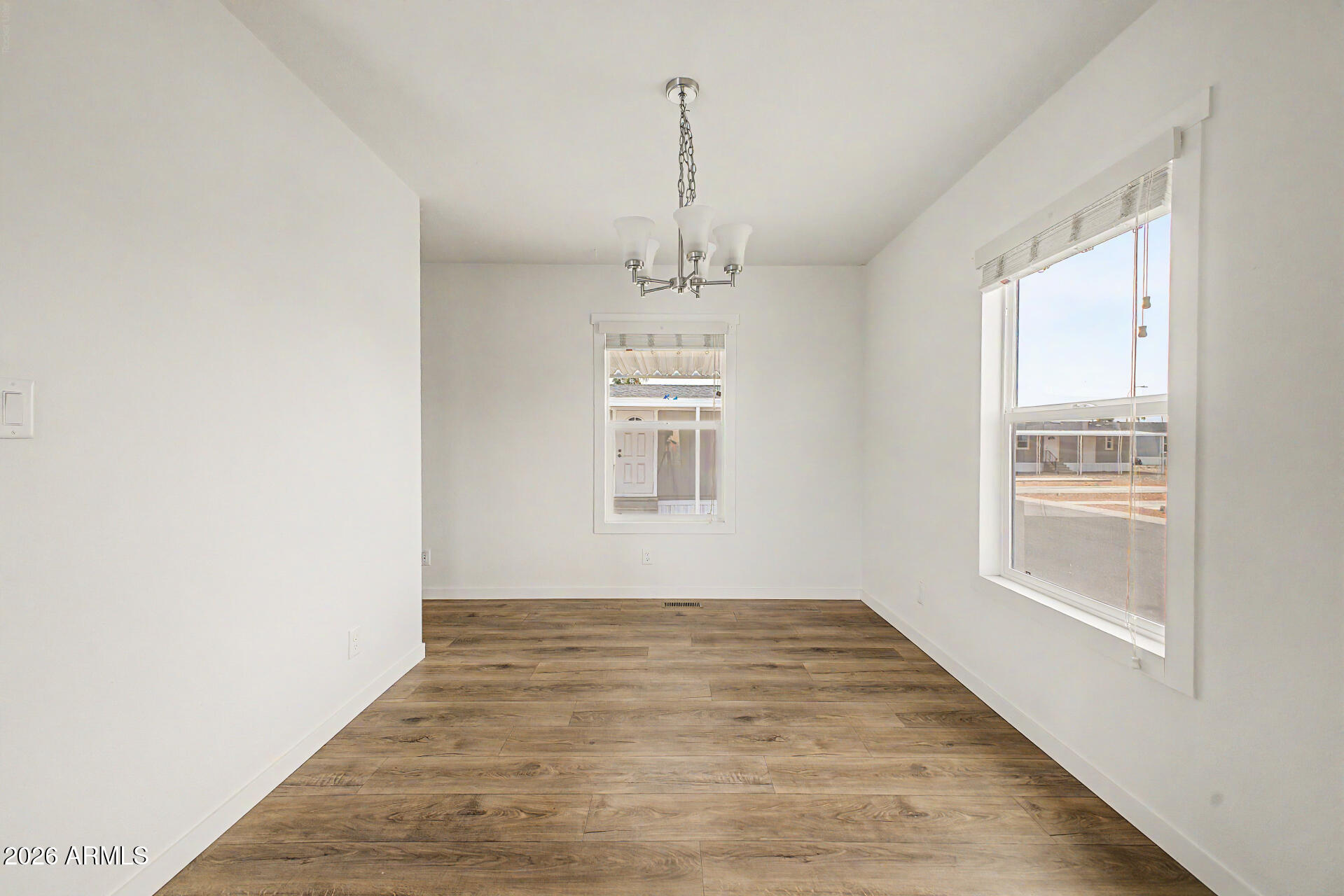 320 East McKellips Road, Unit 100 Mesa, AZ 85201 - Photo 7 of 24 a view of empty room with wooden floor and fan