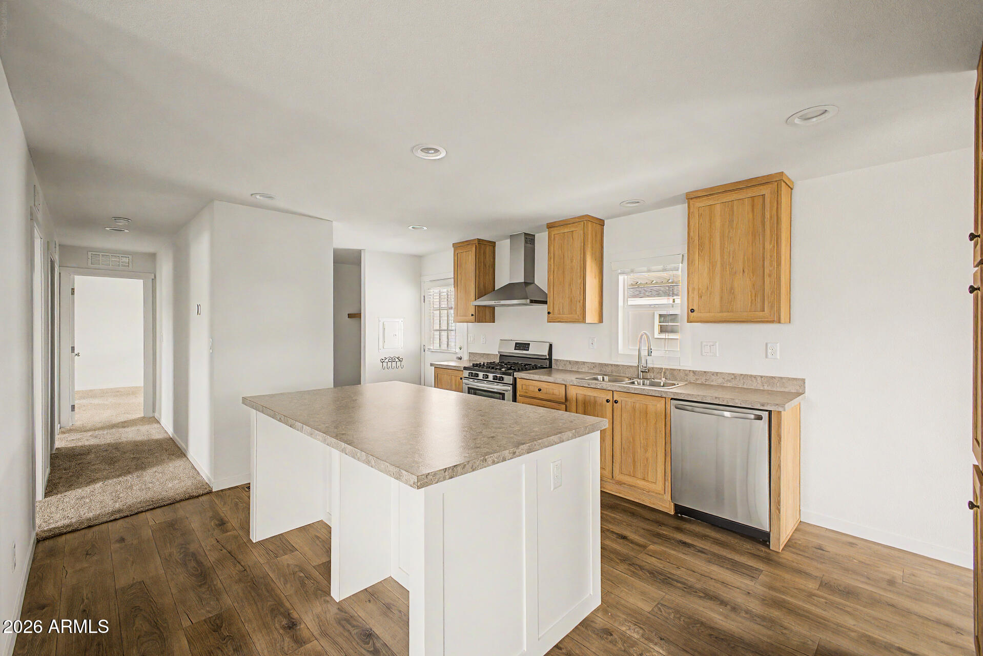 320 East McKellips Road, Unit 100 Mesa, AZ 85201 - Photo 10 of 24 a kitchen with stainless steel appliances granite countertop a sink stove and cabinets