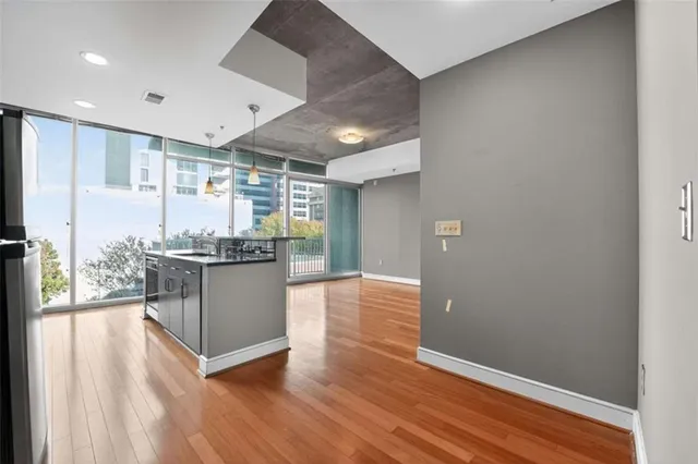 a kitchen with stainless steel appliances granite countertop a stove and a wooden floors