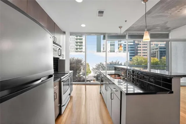 a kitchen with counter top space and windows