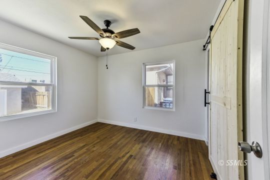 329 North Balsam Street Ridgecrest, CA 93555 - Photo 20 of 27 wooden floor in an empty room with a window