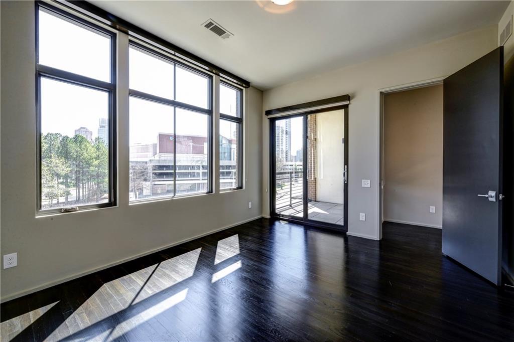721 Longleaf Drive Northeast, Unit 8 Atlanta, GA 30342 - Photo 22 of 24 a view of an empty room with wooden floor and a window