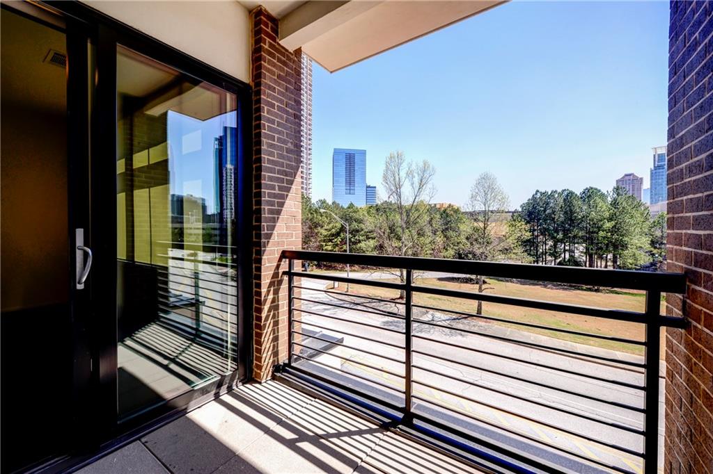 721 Longleaf Drive Northeast, Unit 8 Atlanta, GA 30342 - Photo 24 of 24 a view of a balcony with wooden floor and stairs
