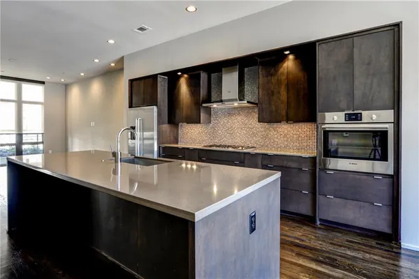 a kitchen with a sink stainless steel appliances and cabinets