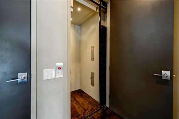 a view of an entryway with wooden floor