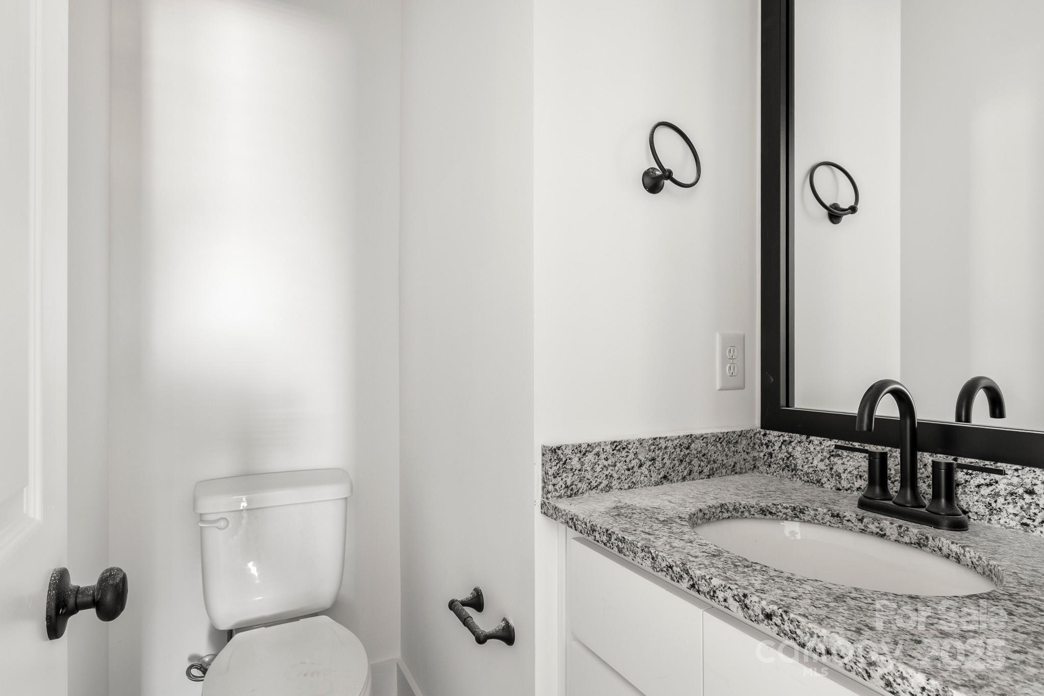 3307 Old Pageland Monroe Road Monroe, NC 28112 - Photo 13 of 35 a bathroom with a granite countertop sink toilet and mirror