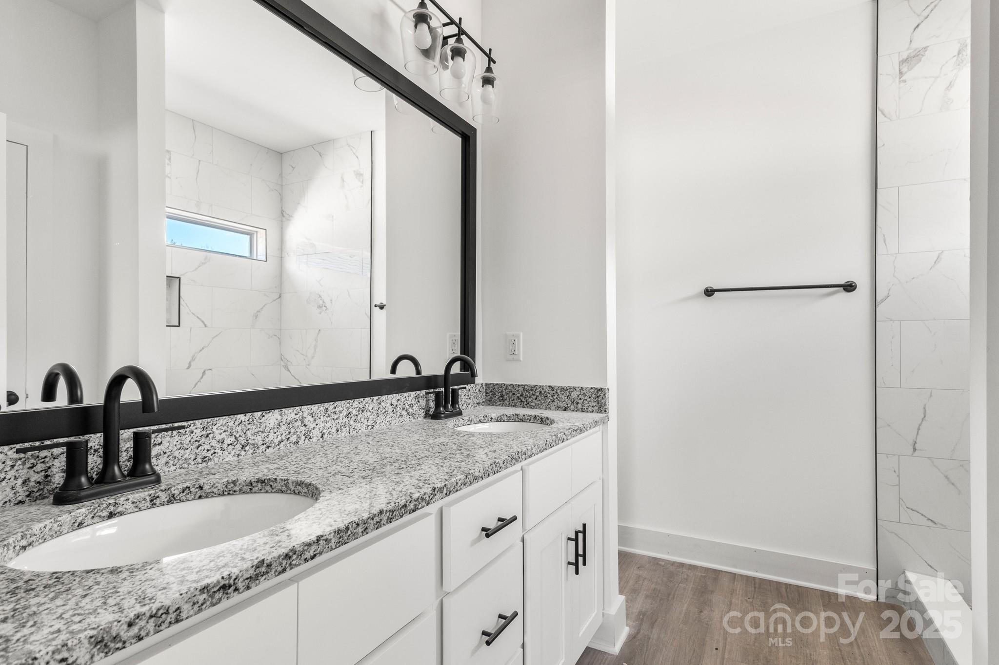 3307 Old Pageland Monroe Road Monroe, NC 28112 - Photo 16 of 35 a bathroom with a granite countertop sink and a mirror