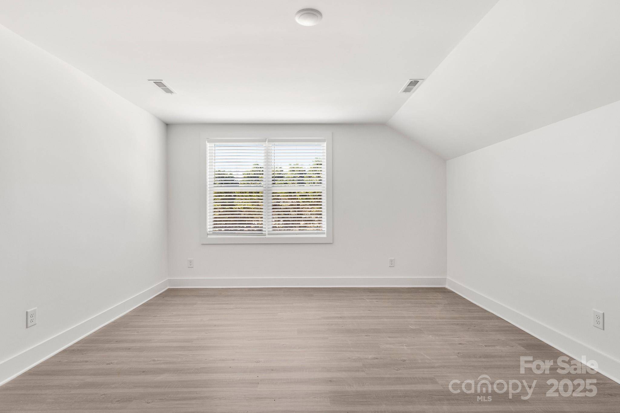 3307 Old Pageland Monroe Road Monroe, NC 28112 - Photo 30 of 35 an empty room with wooden floor and windows