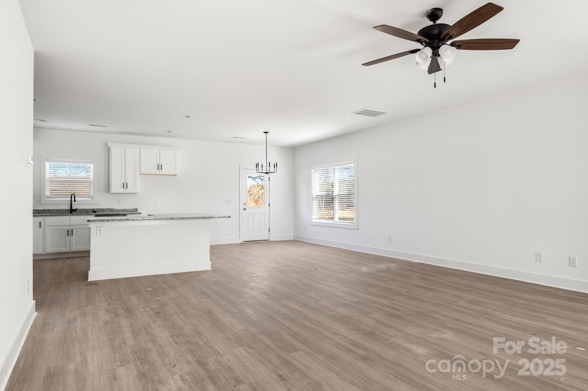 3307 Old Pageland Monroe Road Monroe, NC 28112 - Photo 5 of 35 a view of a kitchen with a sink and dishwasher a kitchen island with wooden floor