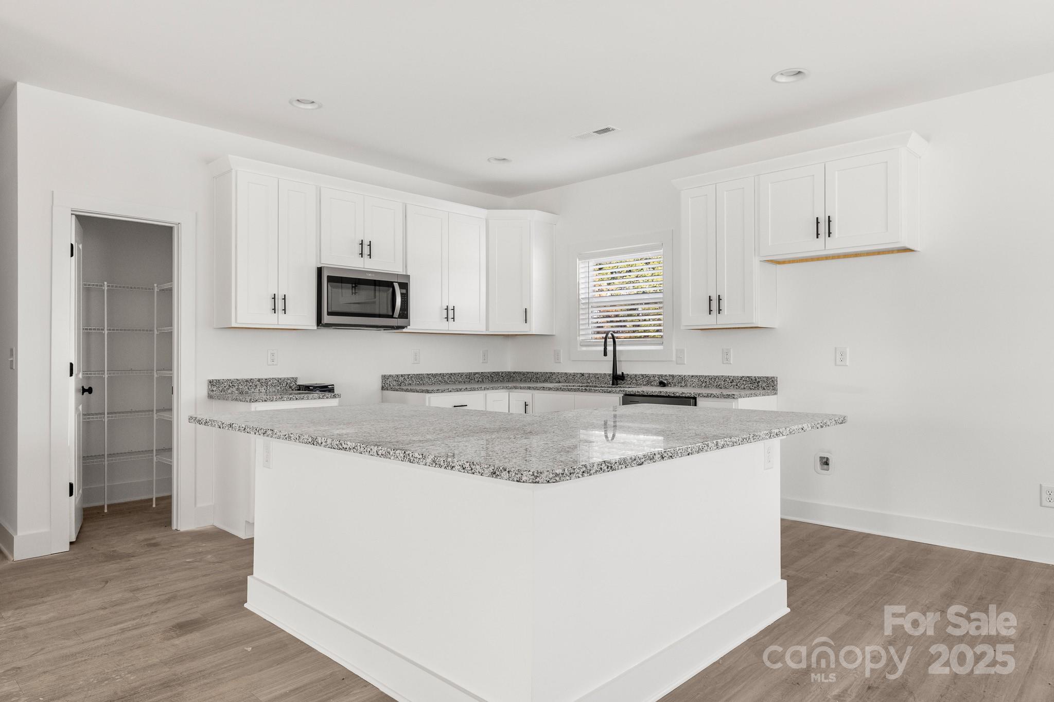 3307 Old Pageland Monroe Road Monroe, NC 28112 - Photo 8 of 35 a kitchen with granite countertop a sink stove and cabinets