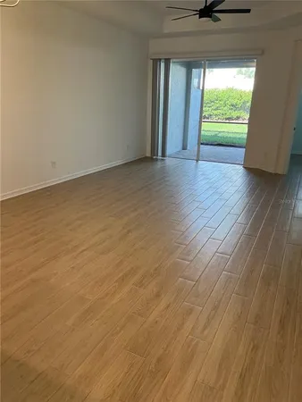 an empty room with wooden floor and a window