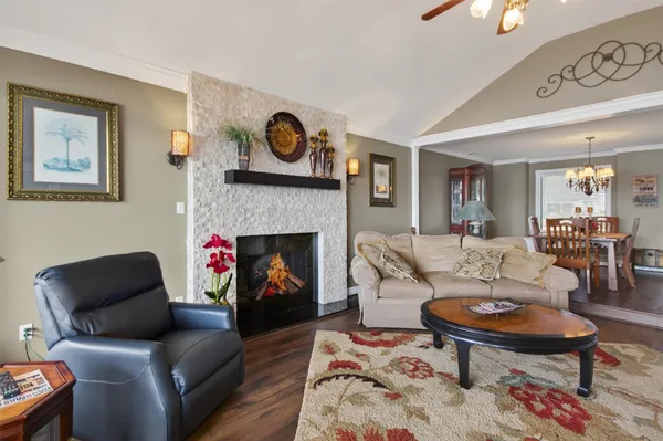 a kitchen with granite countertop a stove top oven a sink a dining table and chairs