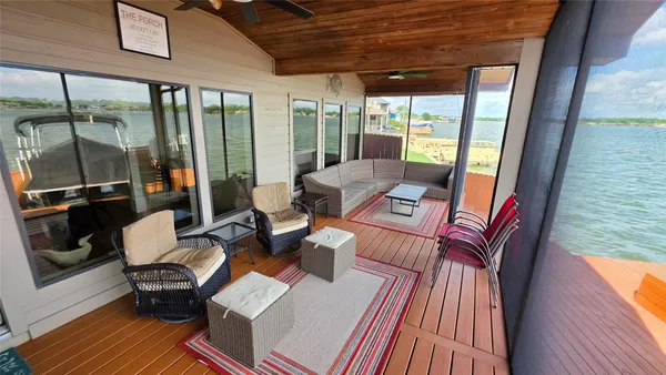 a view of a balcony with furniture and wooden floor