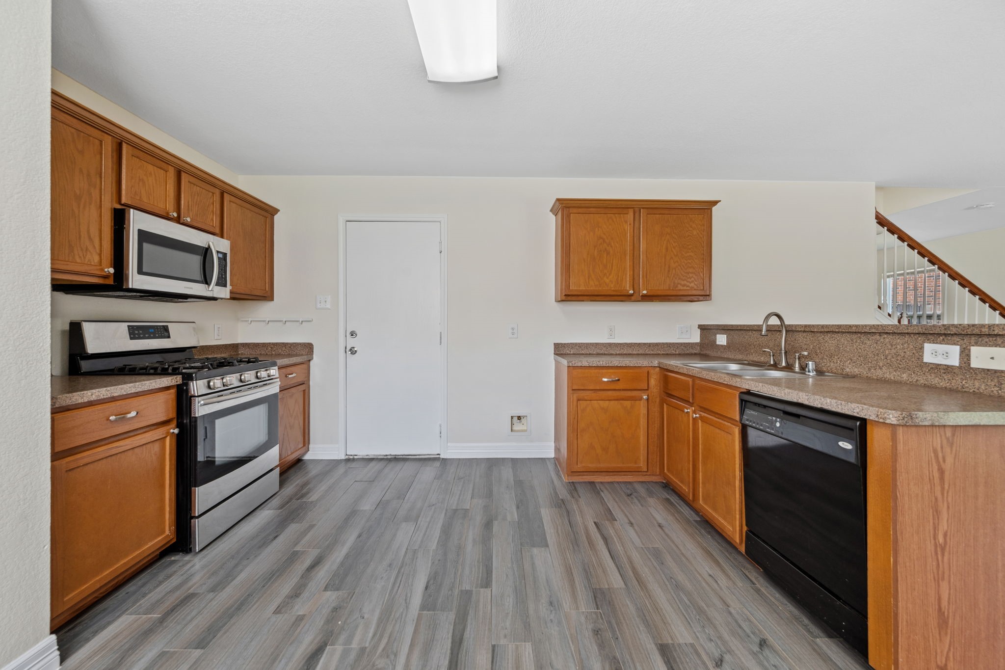 12819 Blue Timbers Court Houston, TX 77044 - Photo 2 of 26 a kitchen with granite countertop a stove top oven and sink