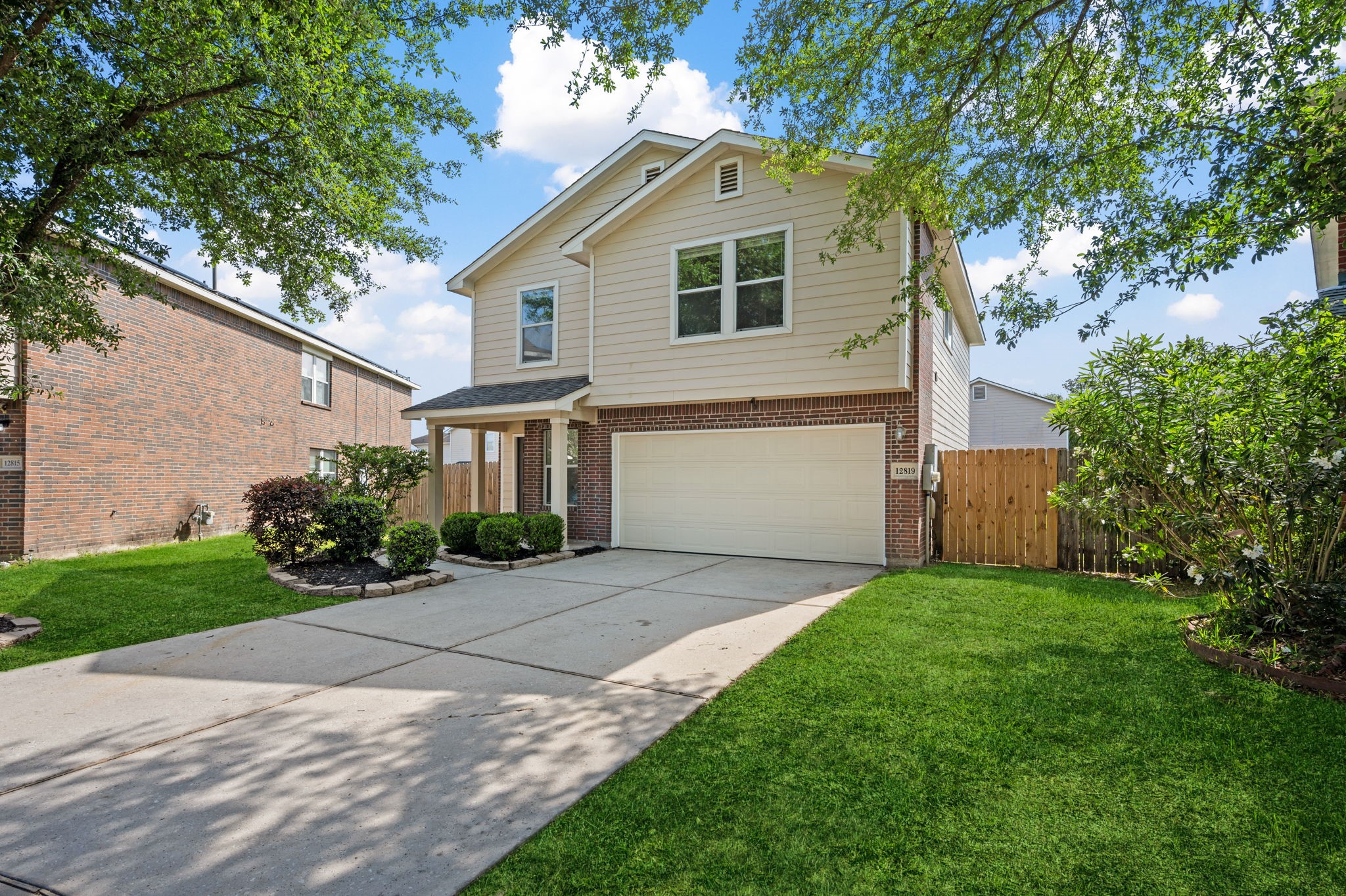 12819 Blue Timbers Court Houston, TX 77044 - Photo 26 of 26 a front view of a house with a yard and a garage