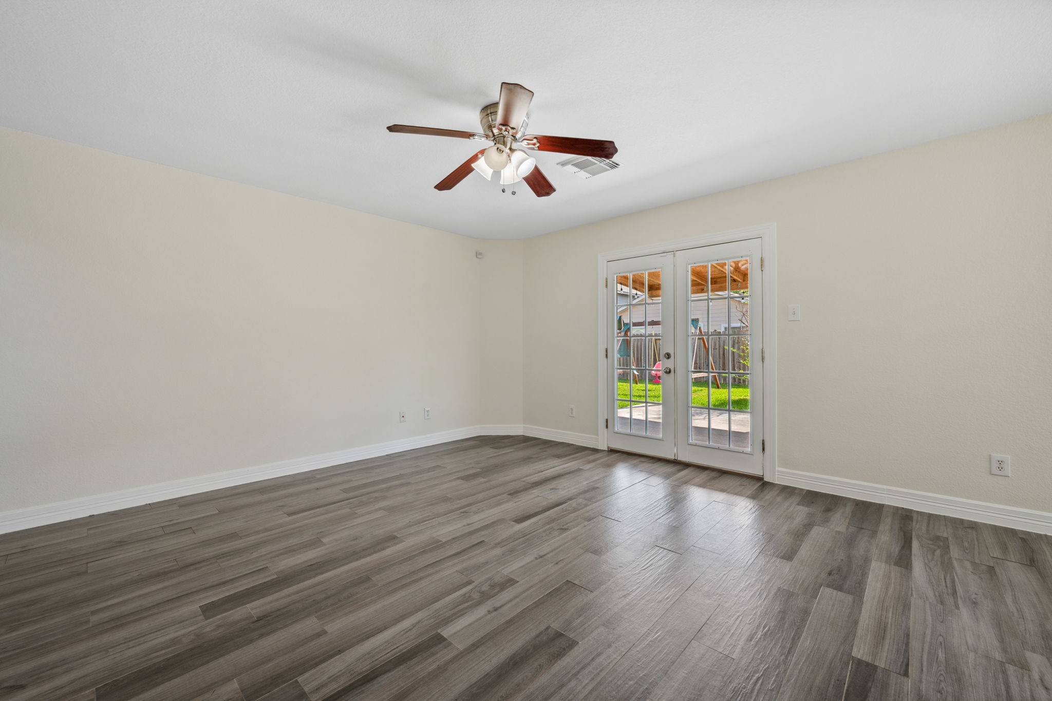 12819 Blue Timbers Court Houston, TX 77044 - Photo 3 of 26 a view of an empty room with window and wooden floor