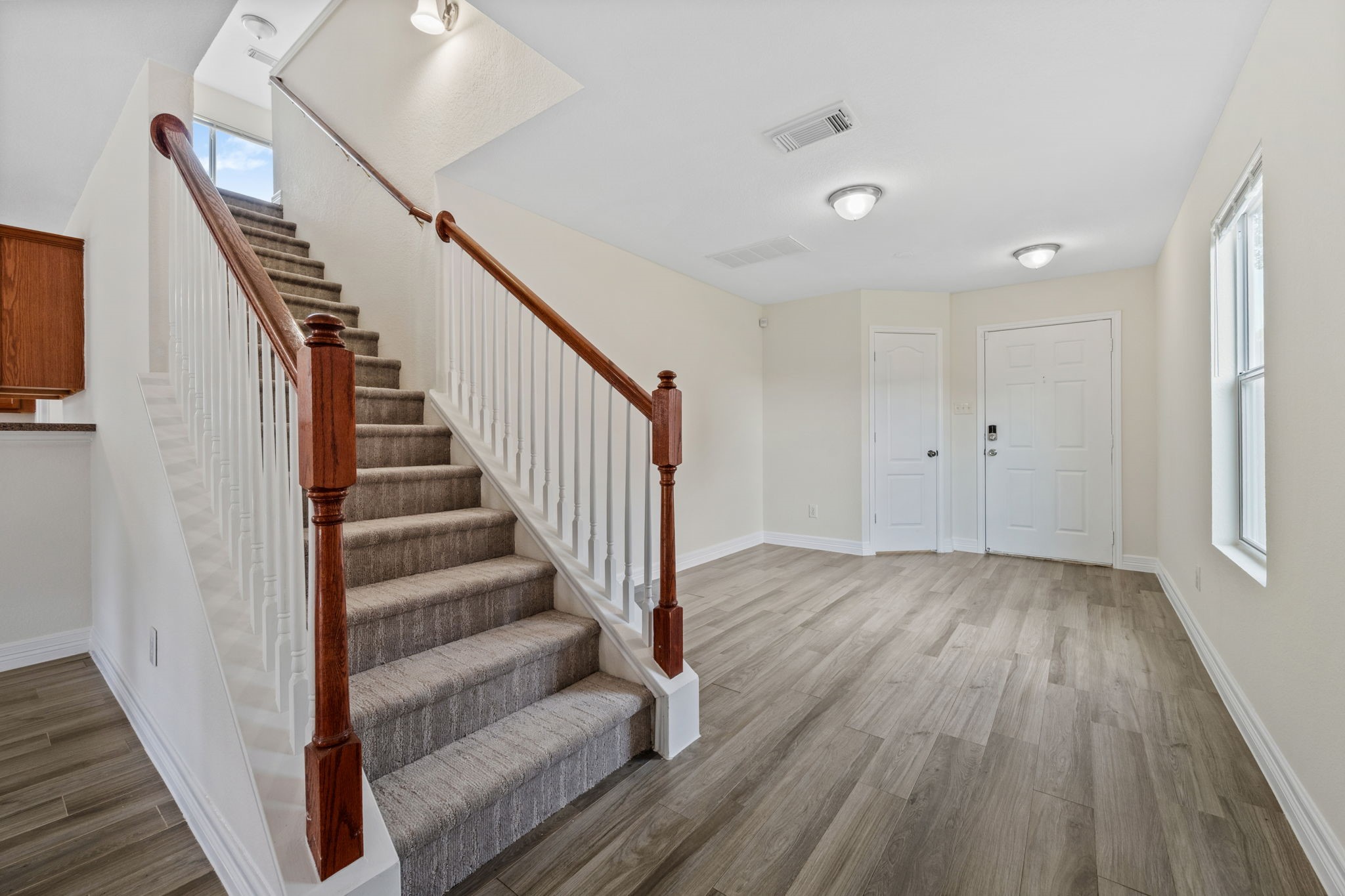 12819 Blue Timbers Court Houston, TX 77044 - Photo 6 of 26 a view of a hallway with wooden floor and staircase