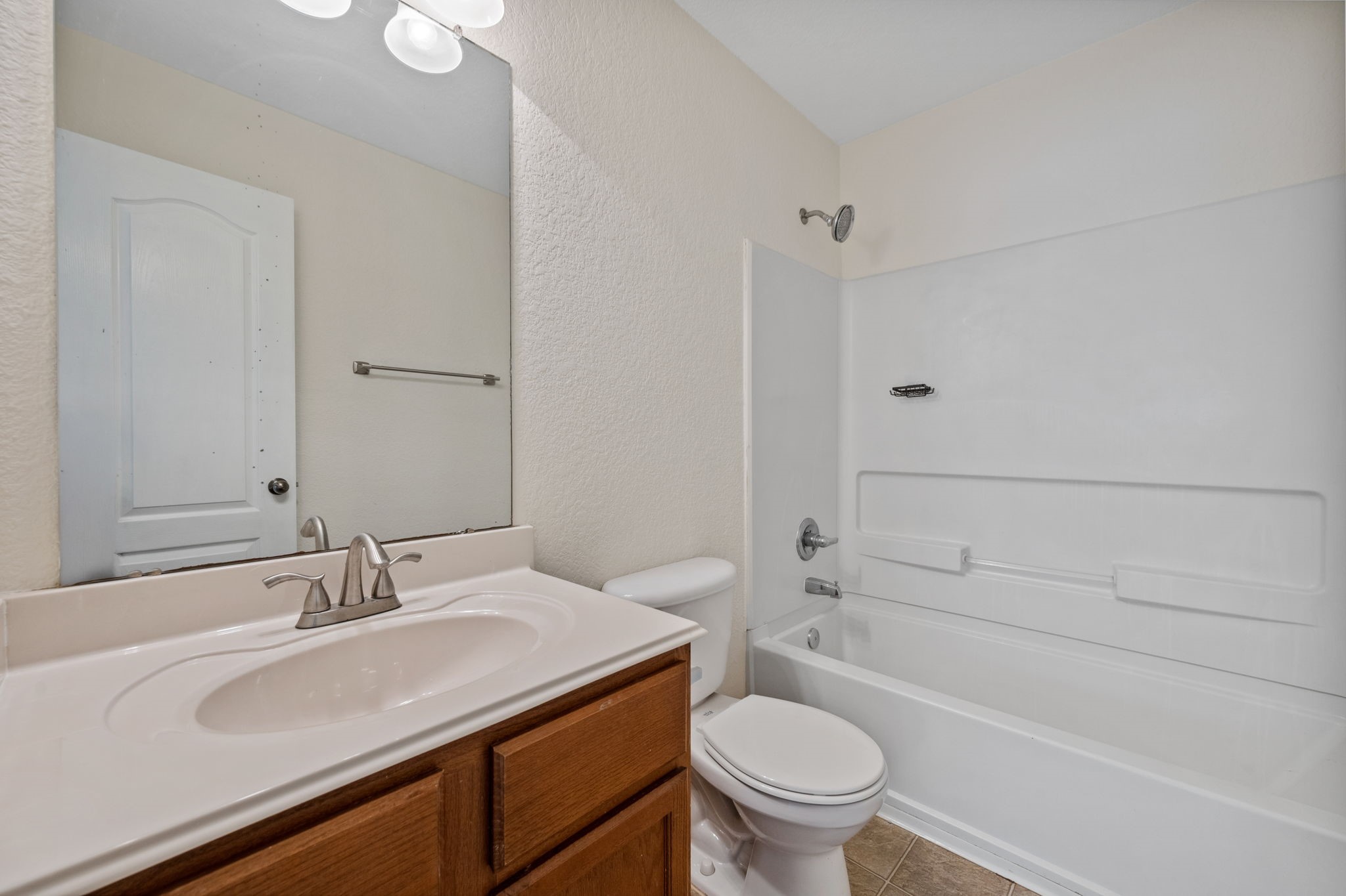 12819 Blue Timbers Court Houston, TX 77044 - Photo 9 of 26 a bathroom with a granite countertop sink toilet and shower