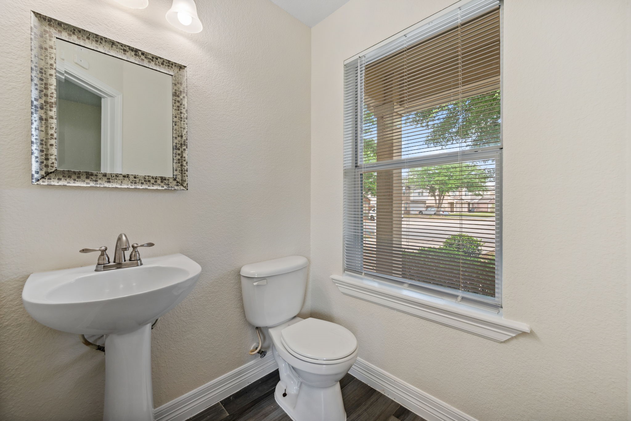 12819 Blue Timbers Court Houston, TX 77044 - Photo 10 of 26 a bathroom with a toilet sink and mirror