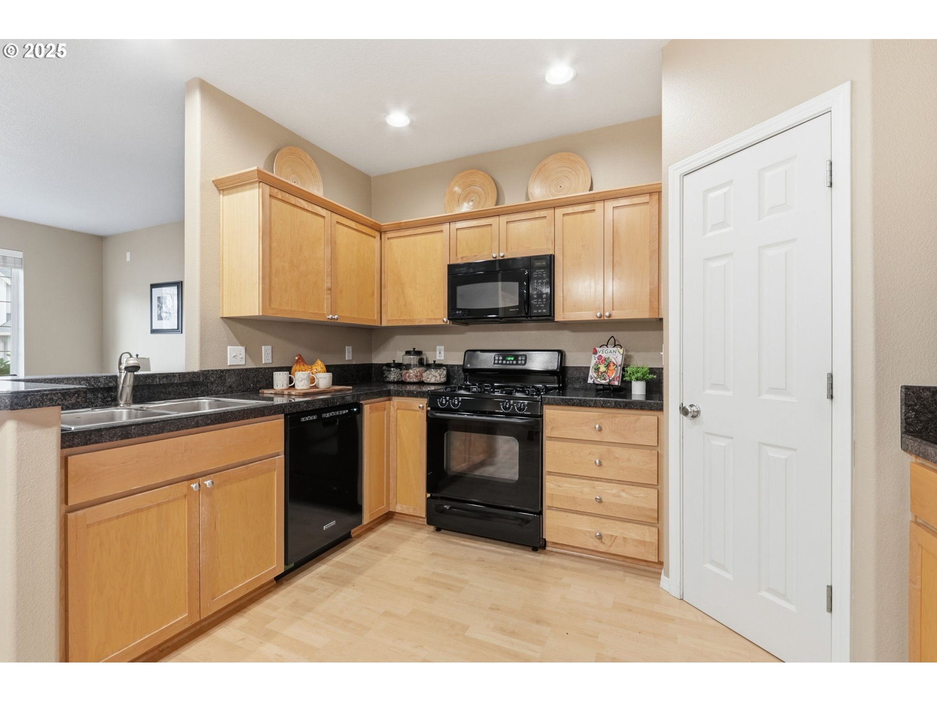 1706 Southwest 172nd Terrace Beaverton, OR 97003 - Photo 12 of 45 a kitchen with stainless steel appliances granite countertop a stove a sink and a microwave