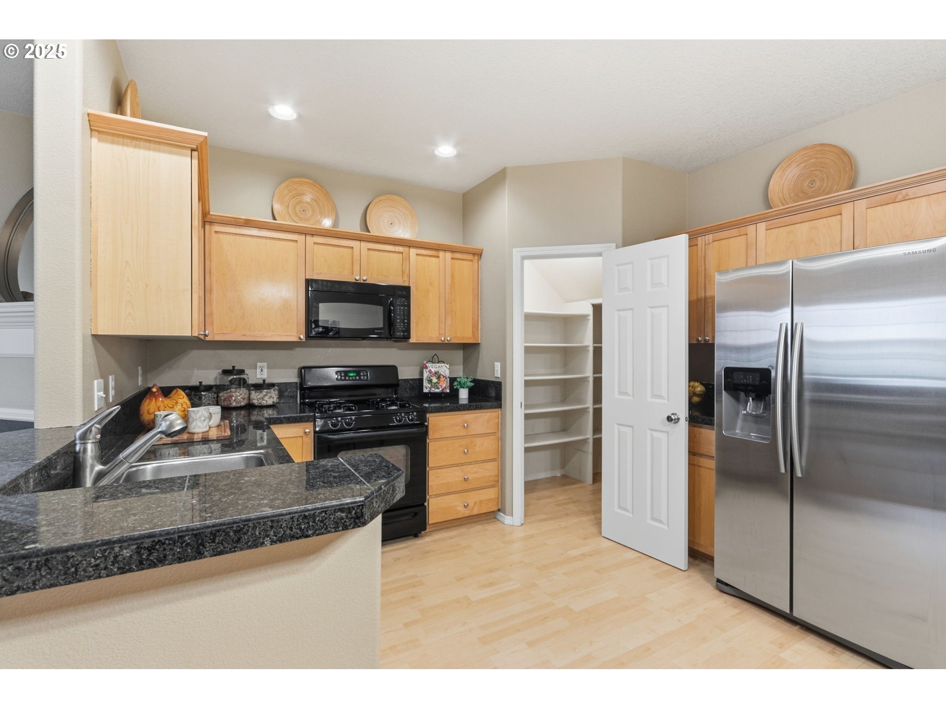 1706 Southwest 172nd Terrace Beaverton, OR 97003 - Photo 13 of 45 a kitchen with granite countertop a refrigerator and a sink