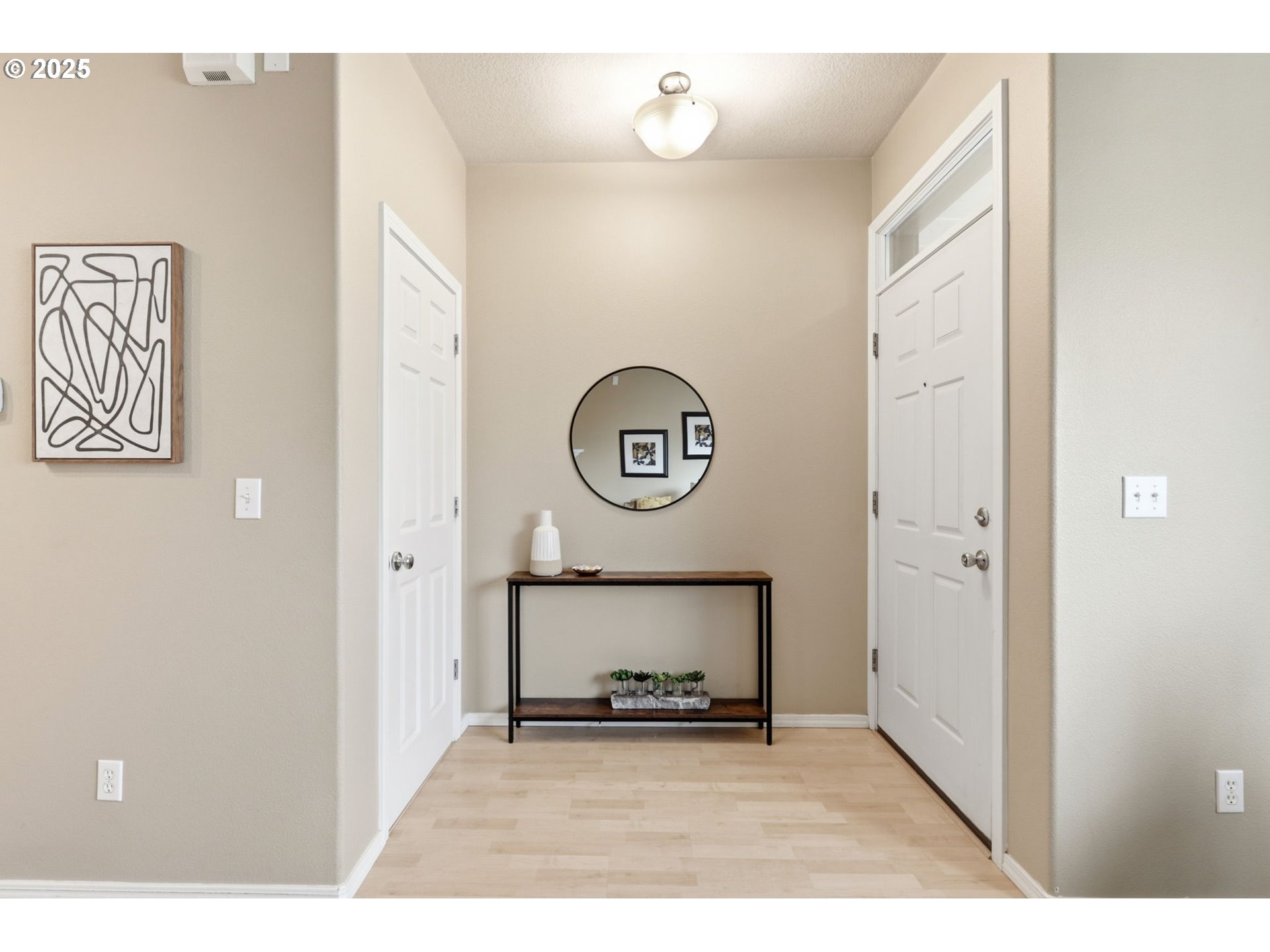 1706 Southwest 172nd Terrace Beaverton, OR 97003 - Photo 3 of 45 a view of a hallway with wooden floor and a cabinet