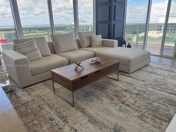 a living room with furniture and a large window