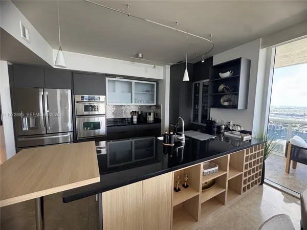 a kitchen with counter top space cabinets and stainless steel appliances