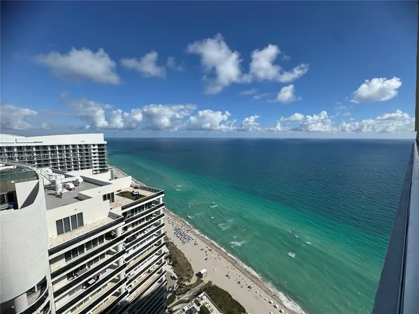 a view of a balcony with an ocean view
