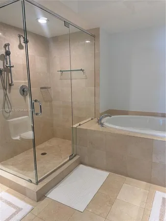 a bathroom with a shower and a bathtub