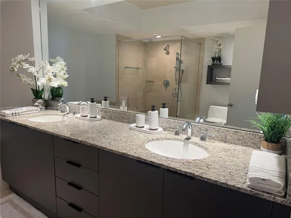 a bathroom with a double vanity sink and a mirror