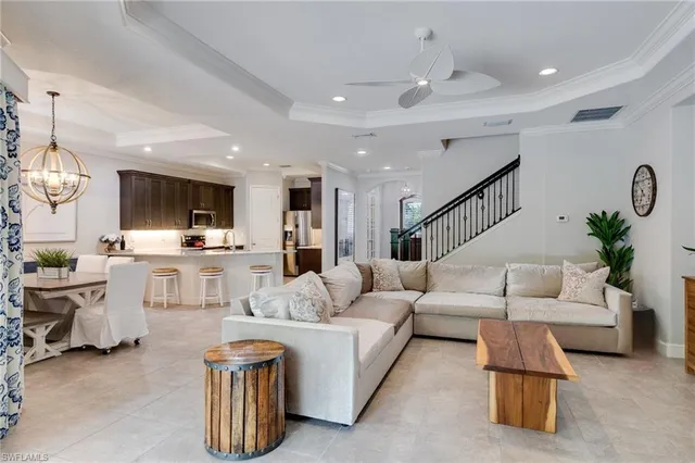 a living room with furniture and kitchen view