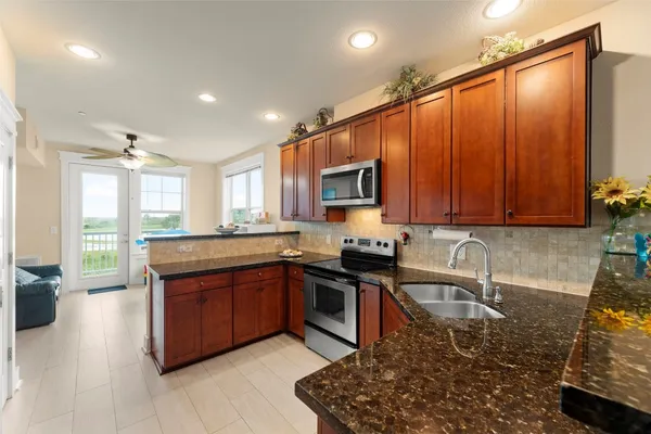 a living room with furniture and kitchen view