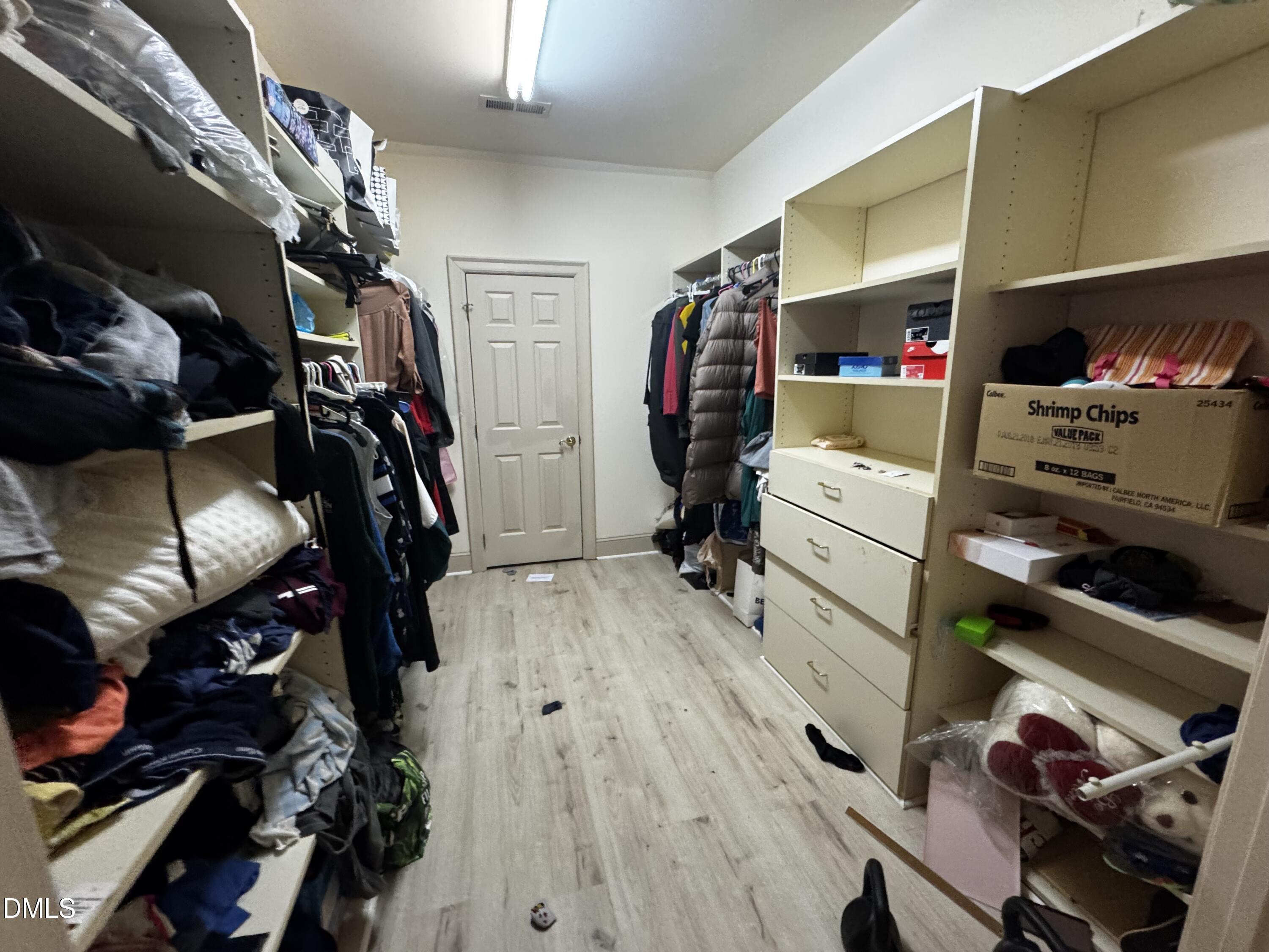6508 Litchford Road Raleigh, NC 27615 - Photo 11 of 17 a view of walk in closet with clothes and shoes