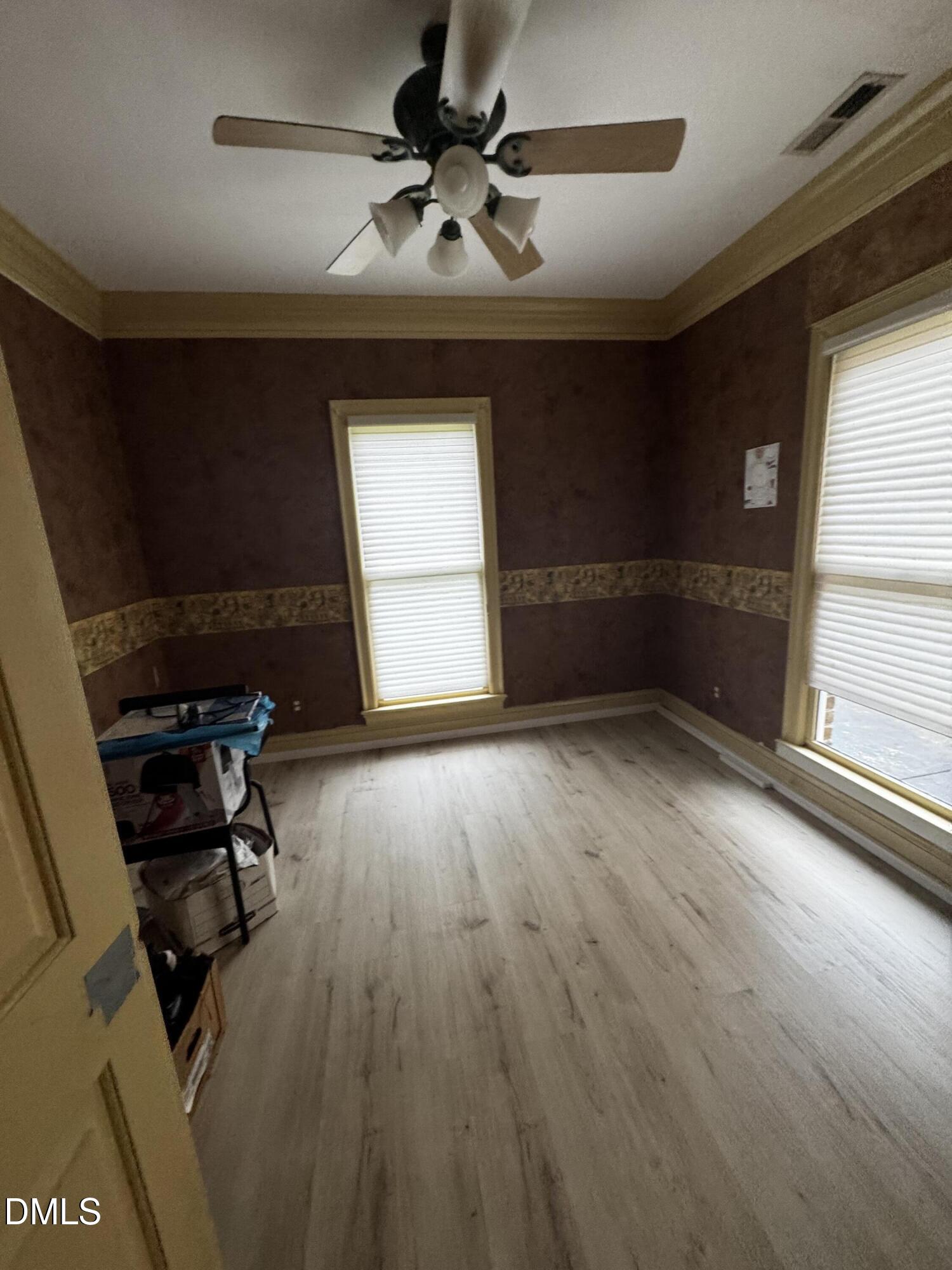 6508 Litchford Road Raleigh, NC 27615 - Photo 12 of 17 a view of empty room with wooden floor and fan