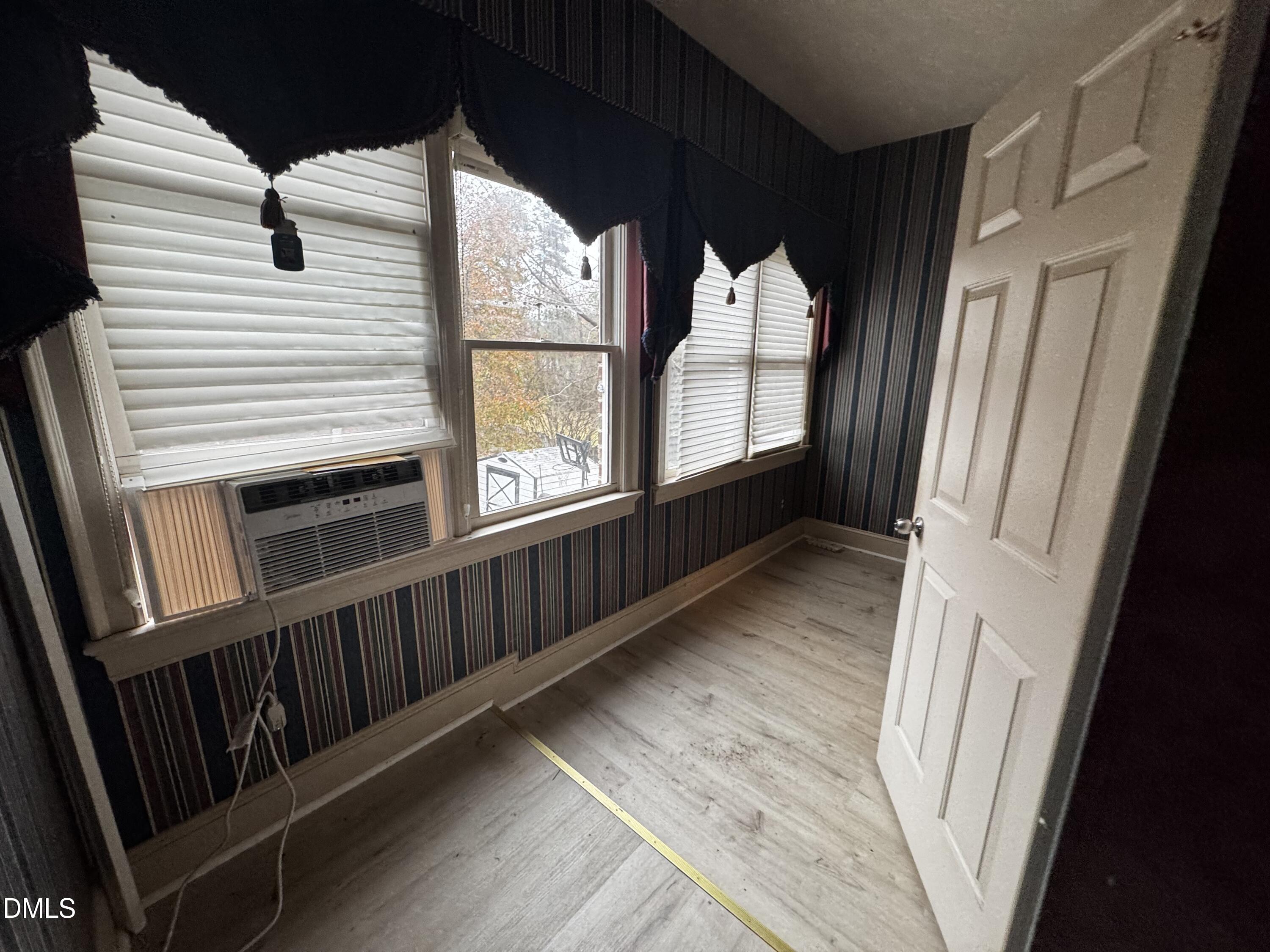 6508 Litchford Road Raleigh, NC 27615 - Photo 15 of 17 a view of wooden floor and windows in a room